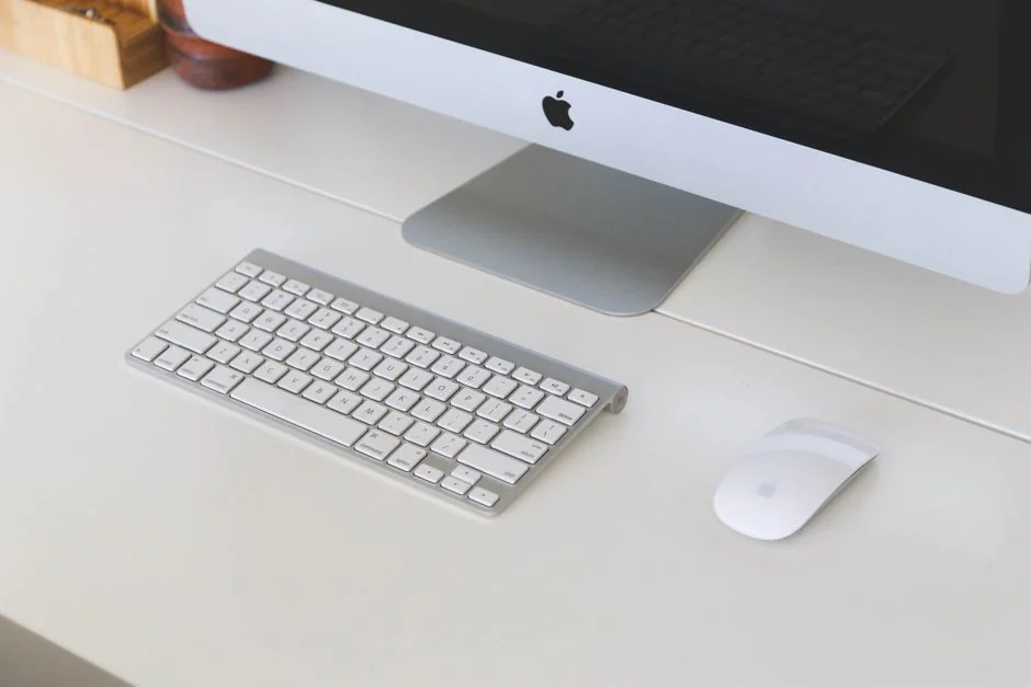 Dual monitors on a desk, showcasing web design in a modern office setting.